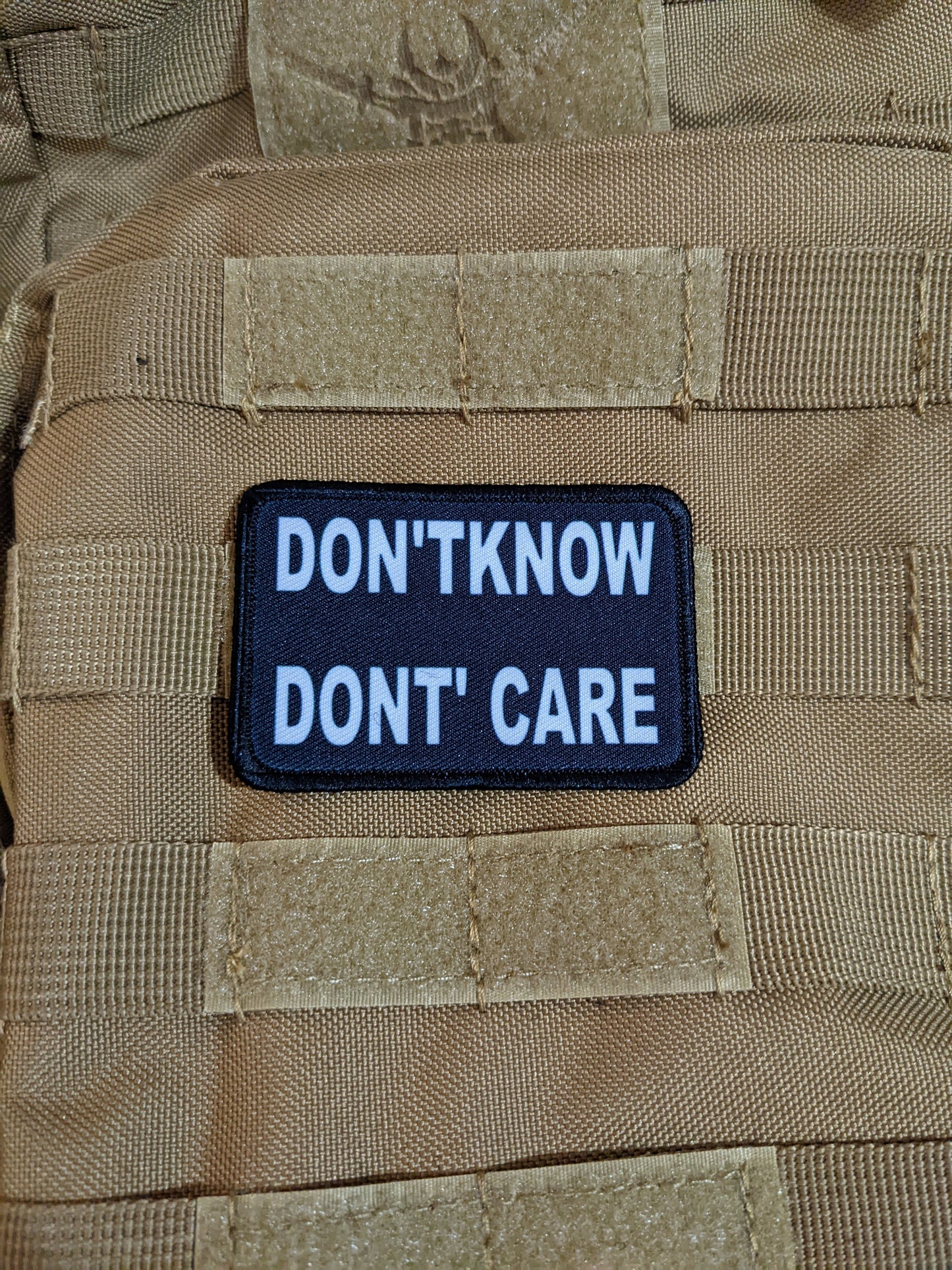 Don't Know Don't Care funny 2"x3" morale patch with hook and loop backing green background
