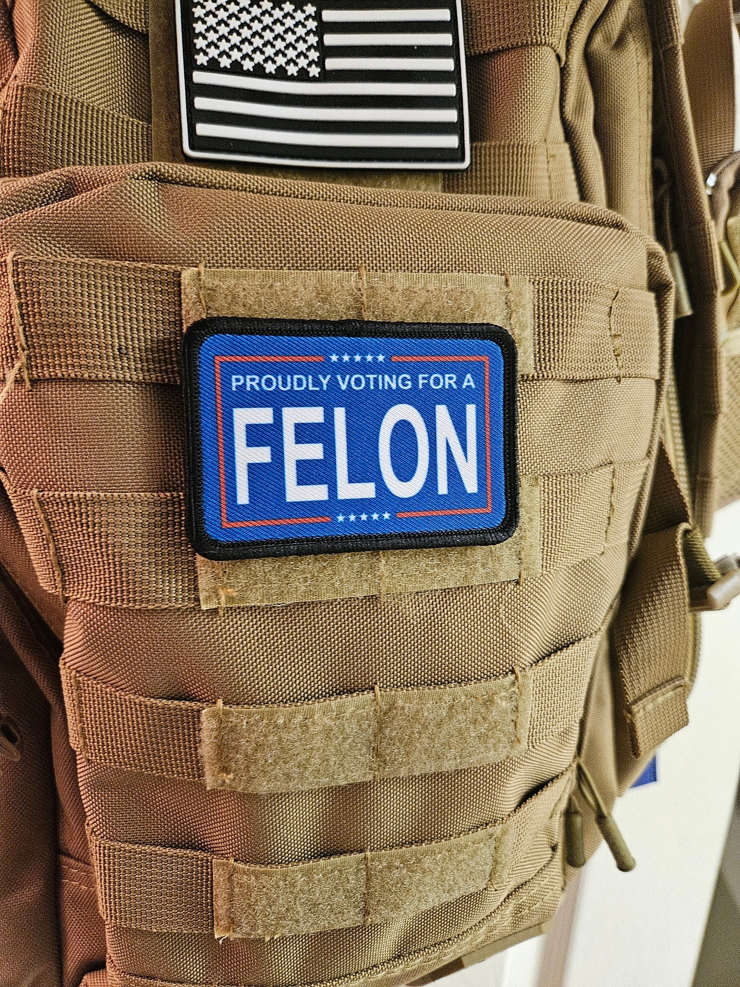 Proudly voting for a felon blue 2"x3" removable morale patch with hook and loop backing meme