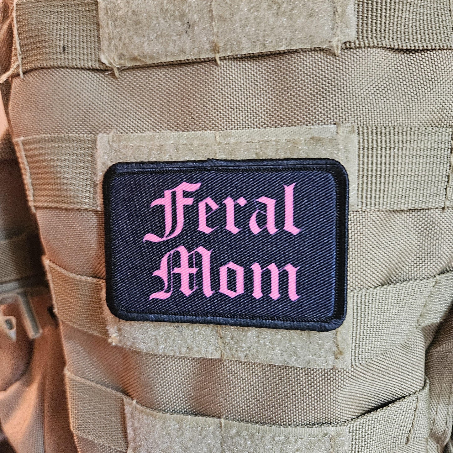 Pink on black "feral mom" girls and boys meme 2"x3" morale patch with hook and loop backing