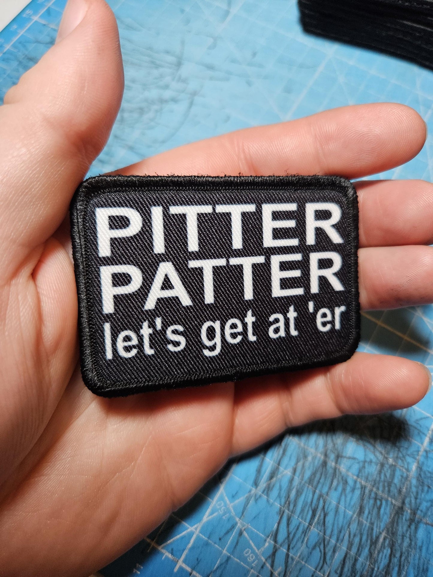Pitter patter let's get at 'er meme 2"x3" removable morale patch with hook and loop backing black and white