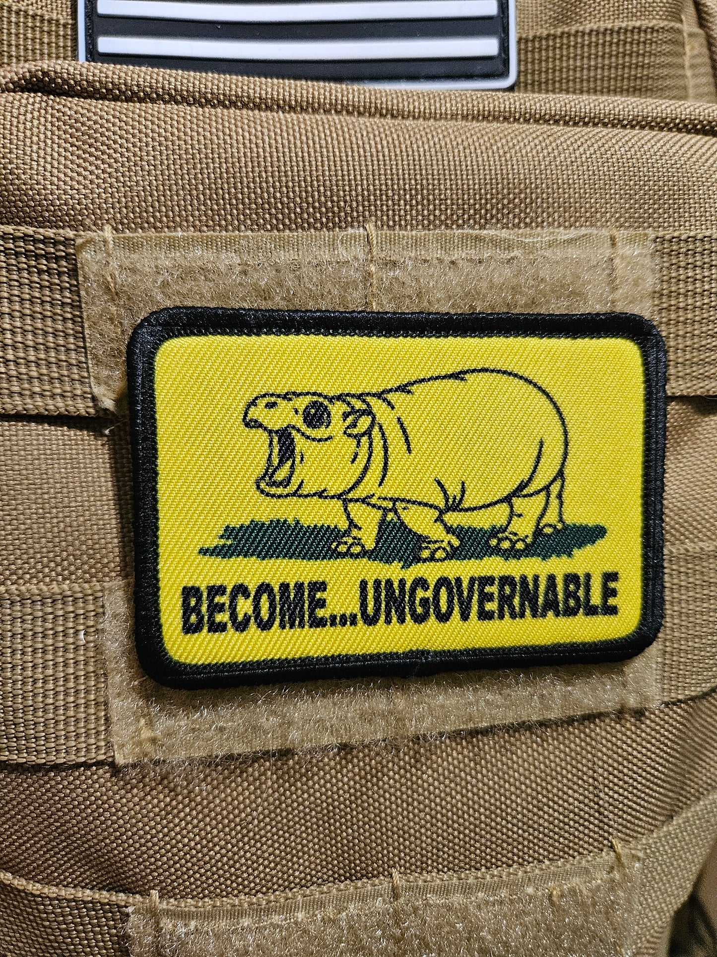 Become ungovernable baby hippo meme 2"x3" morale patch with hook and loop backing line art version