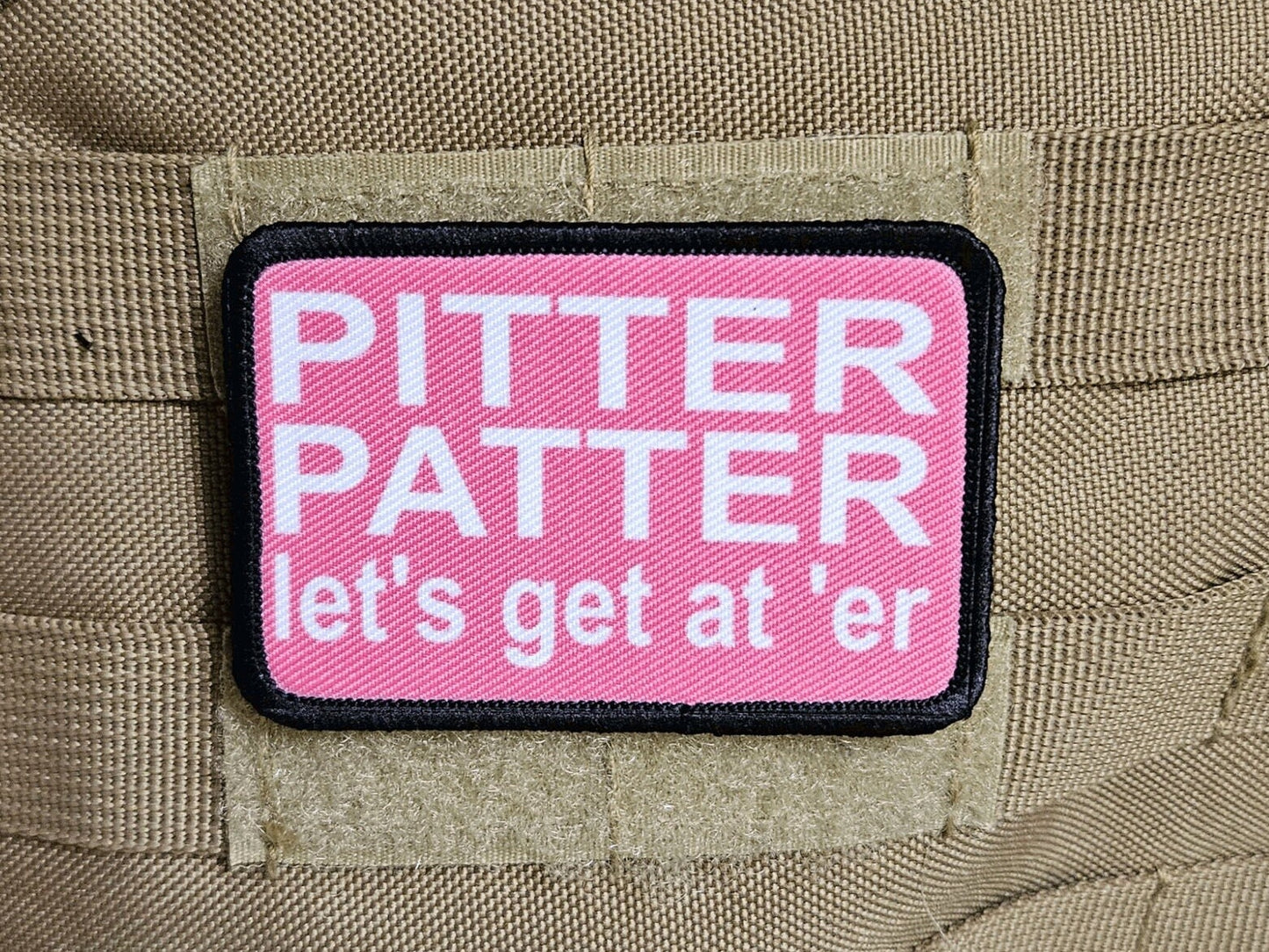 pink and white Pitter patter let's get at 'er meme 2"x3" removable morale patch with hook and loop backing