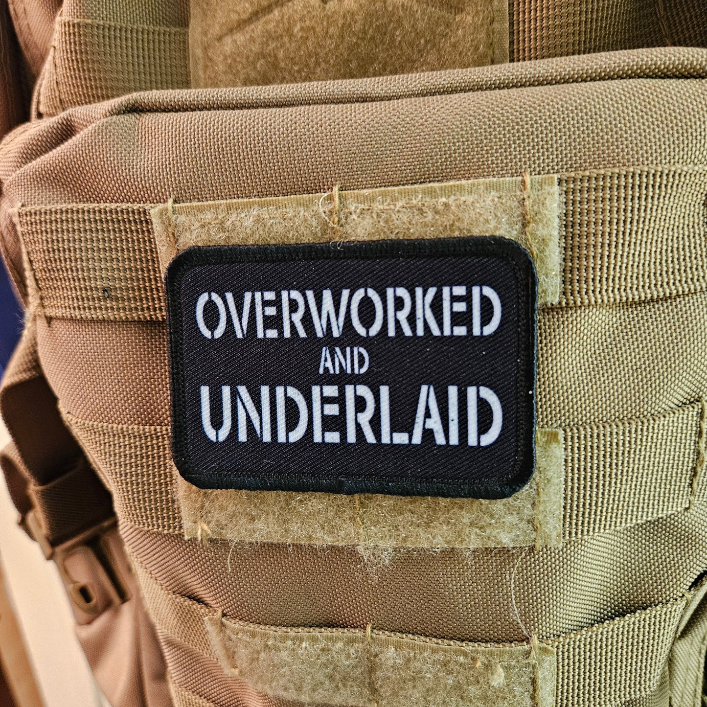 Overworked and underlaid 2"x3" removable morale patch with hook and loop backing black and white