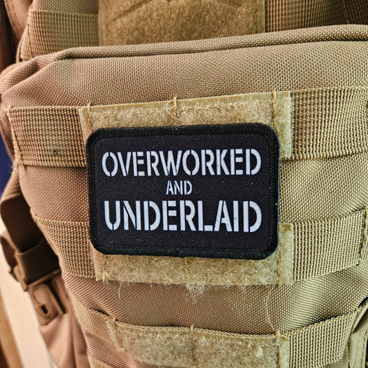 Overworked and underlaid 2"x3" removable morale patch with hook and loop backing black and white