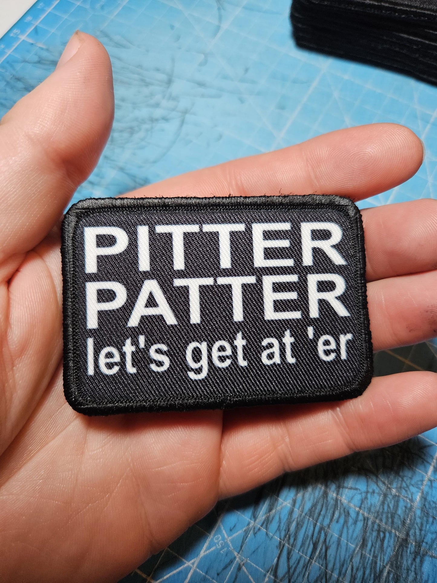 Pitter patter let's get at 'er meme 2"x3" removable morale patch with hook and loop backing black and white