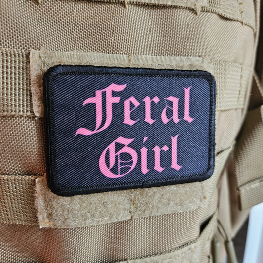 Pink on black "feral girl" girls and boys meme 2"x3" morale patch with hook and loop backing