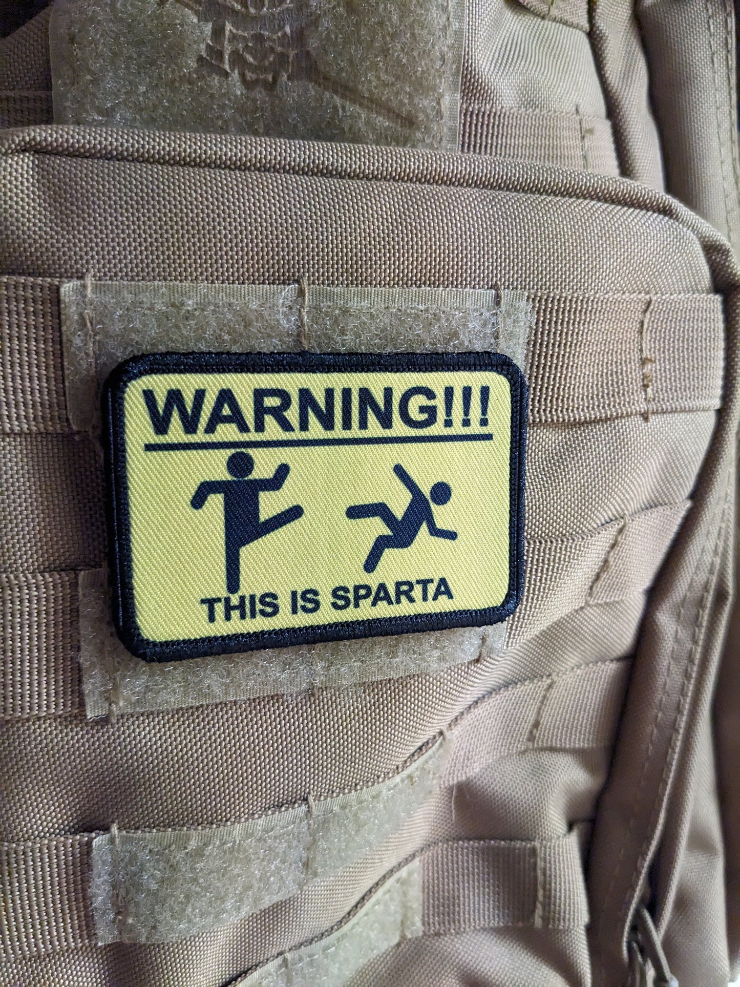 This is Sparta warning sign meme 2"x3" morale patch with hook and loop backing