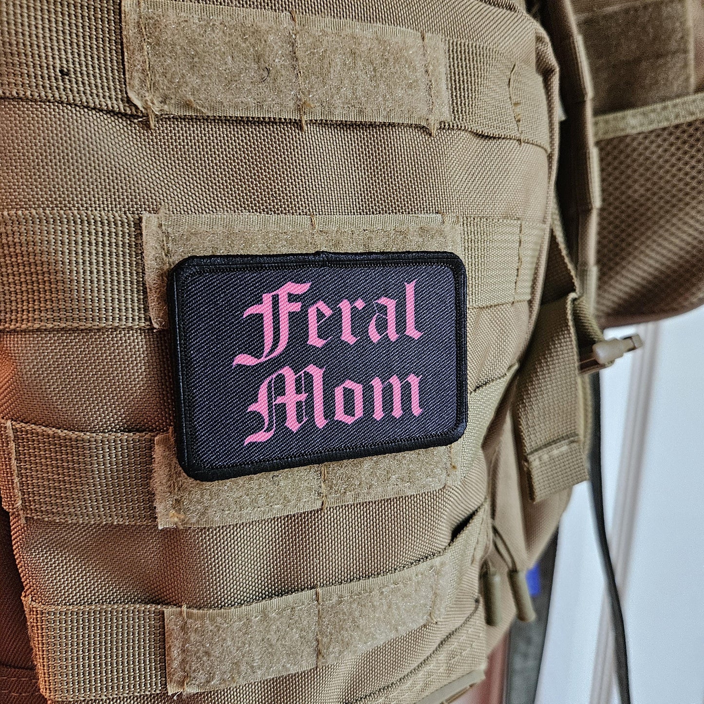 Pink on black "feral mom" girls and boys meme 2"x3" morale patch with hook and loop backing