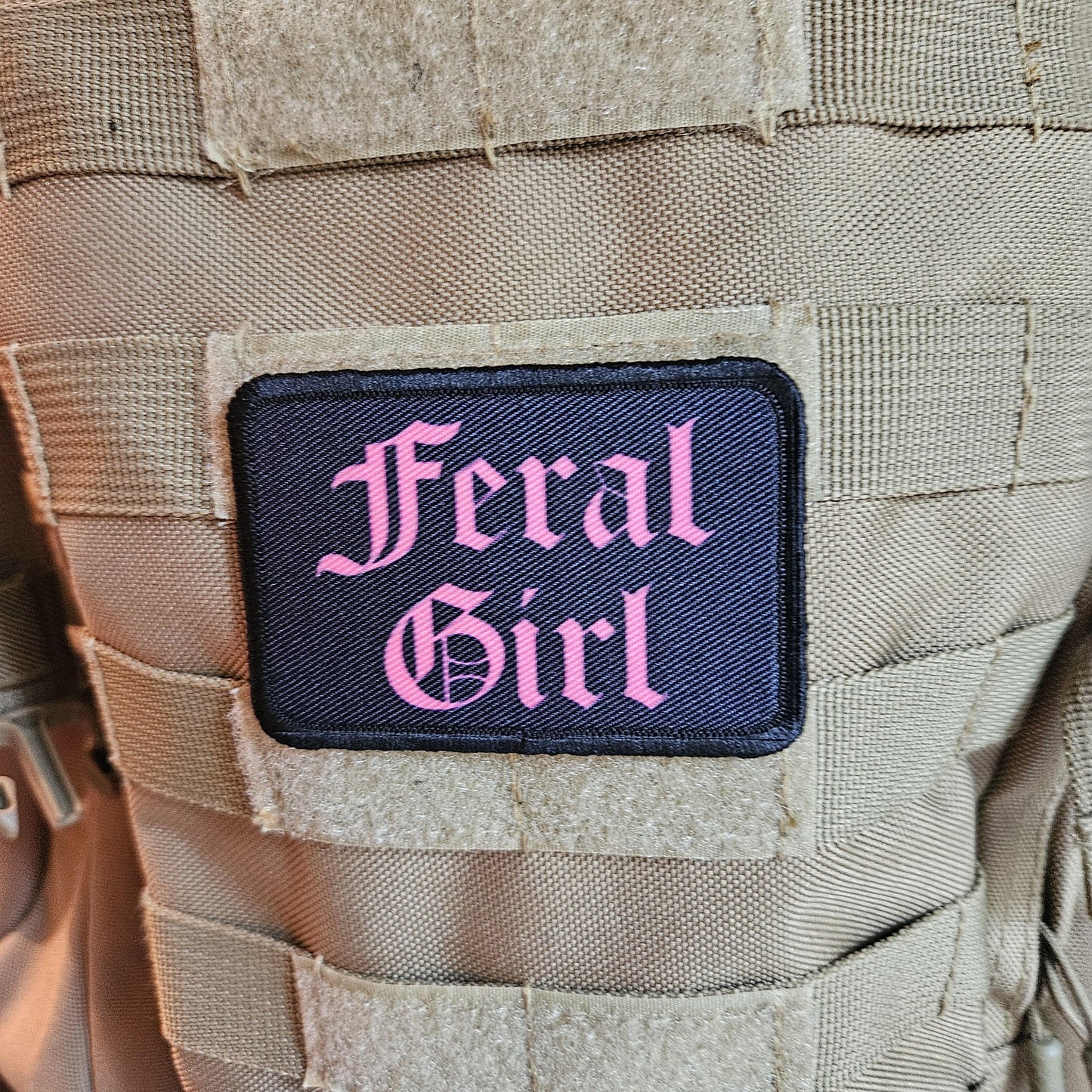 Pink on black "feral girl" girls and boys meme 2"x3" morale patch with hook and loop backing