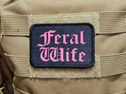 Feral wife meme 2"x3" morale patch with hook and loop backing pink on black