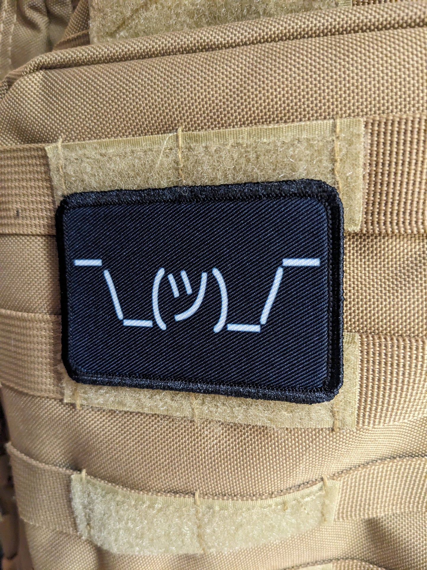 Text idk guy shrugging shoulders black background meme 2"x3" morale patch with hook and loop backing
