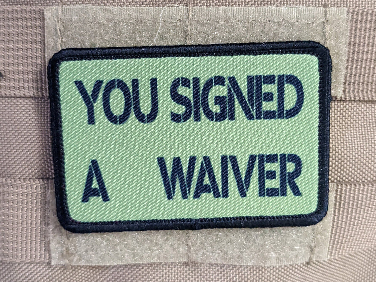 You signed a waiver  removable patch 2"x3" morale patch with hook and loop backing