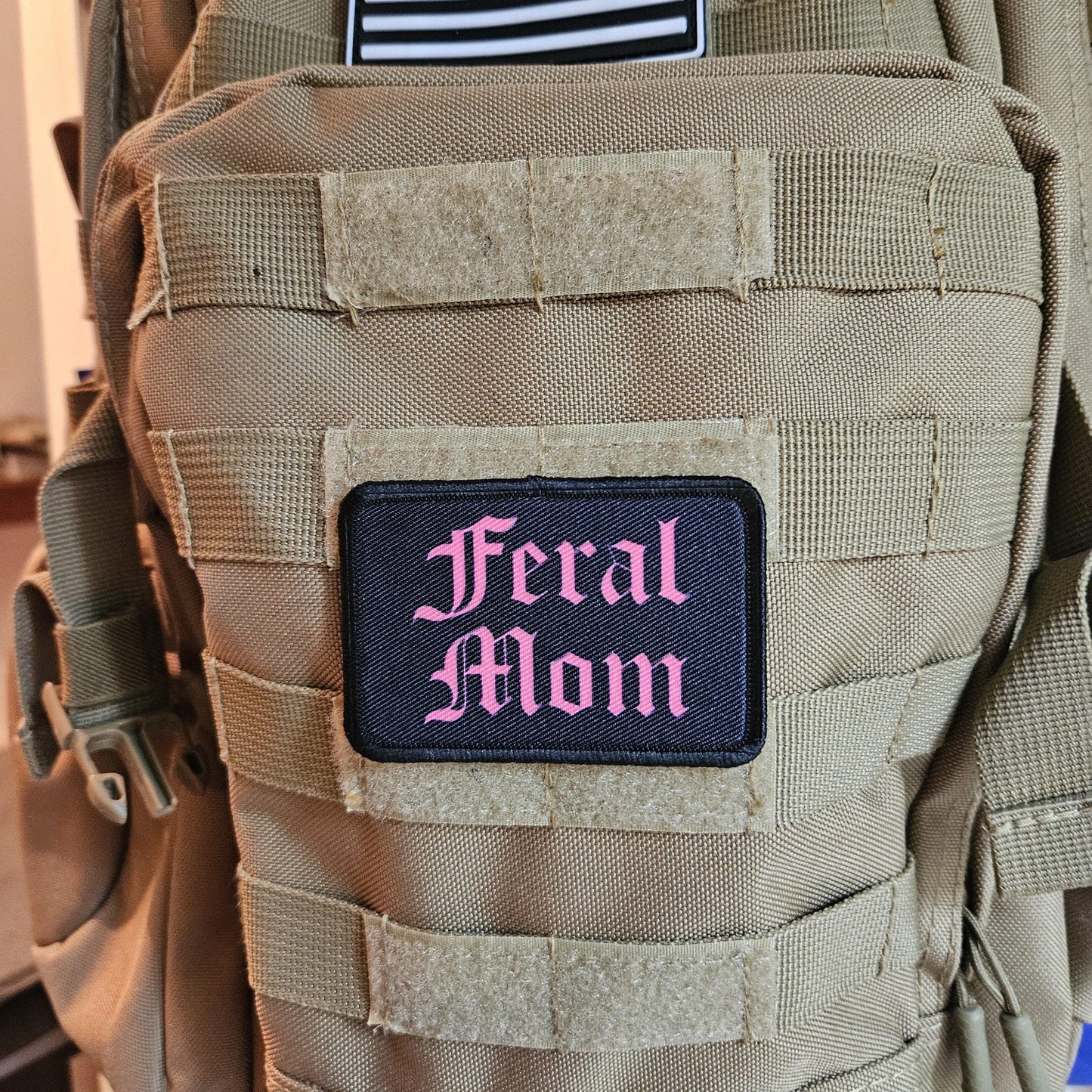 Pink on black "feral mom" girls and boys meme 2"x3" morale patch with hook and loop backing