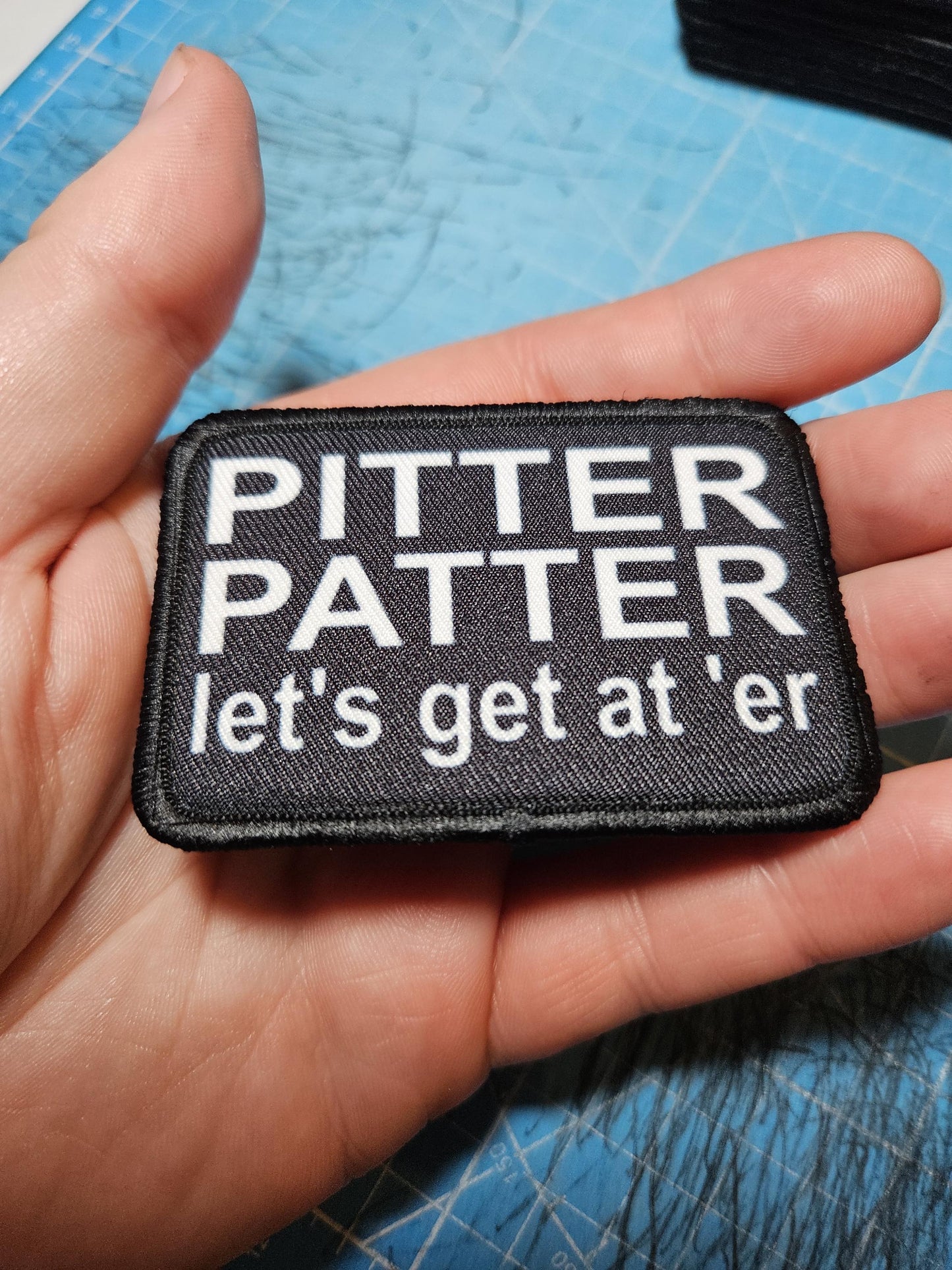 Pitter patter let's get at 'er meme 2"x3" removable morale patch with hook and loop backing black and white