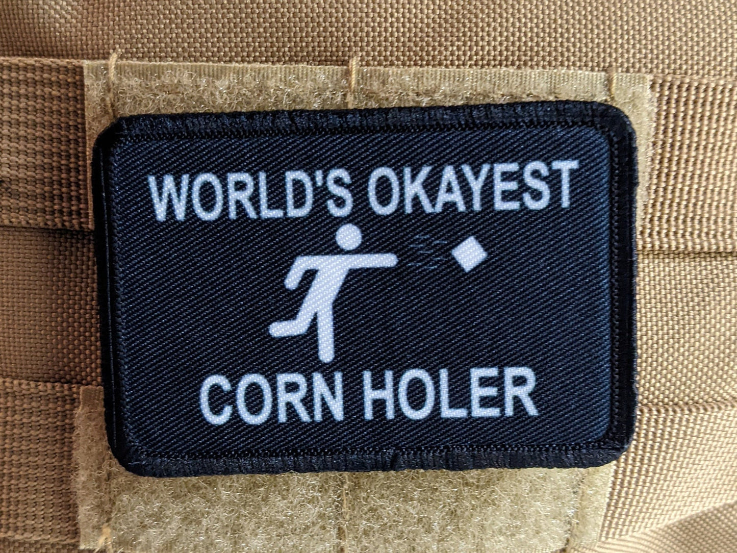 World's Okayest corn hole player funny meme 2"x3" morale patch with hook and loop backing
