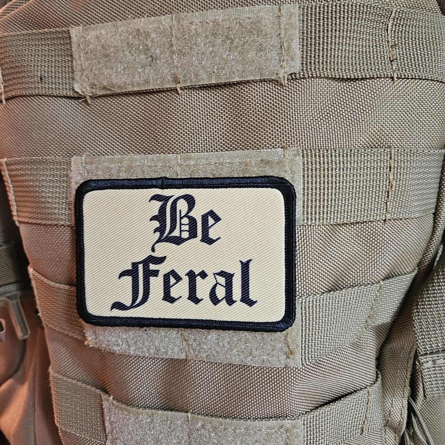 Tan "be feral" girls and boys meme 2"x3" morale patch with hook and loop backing