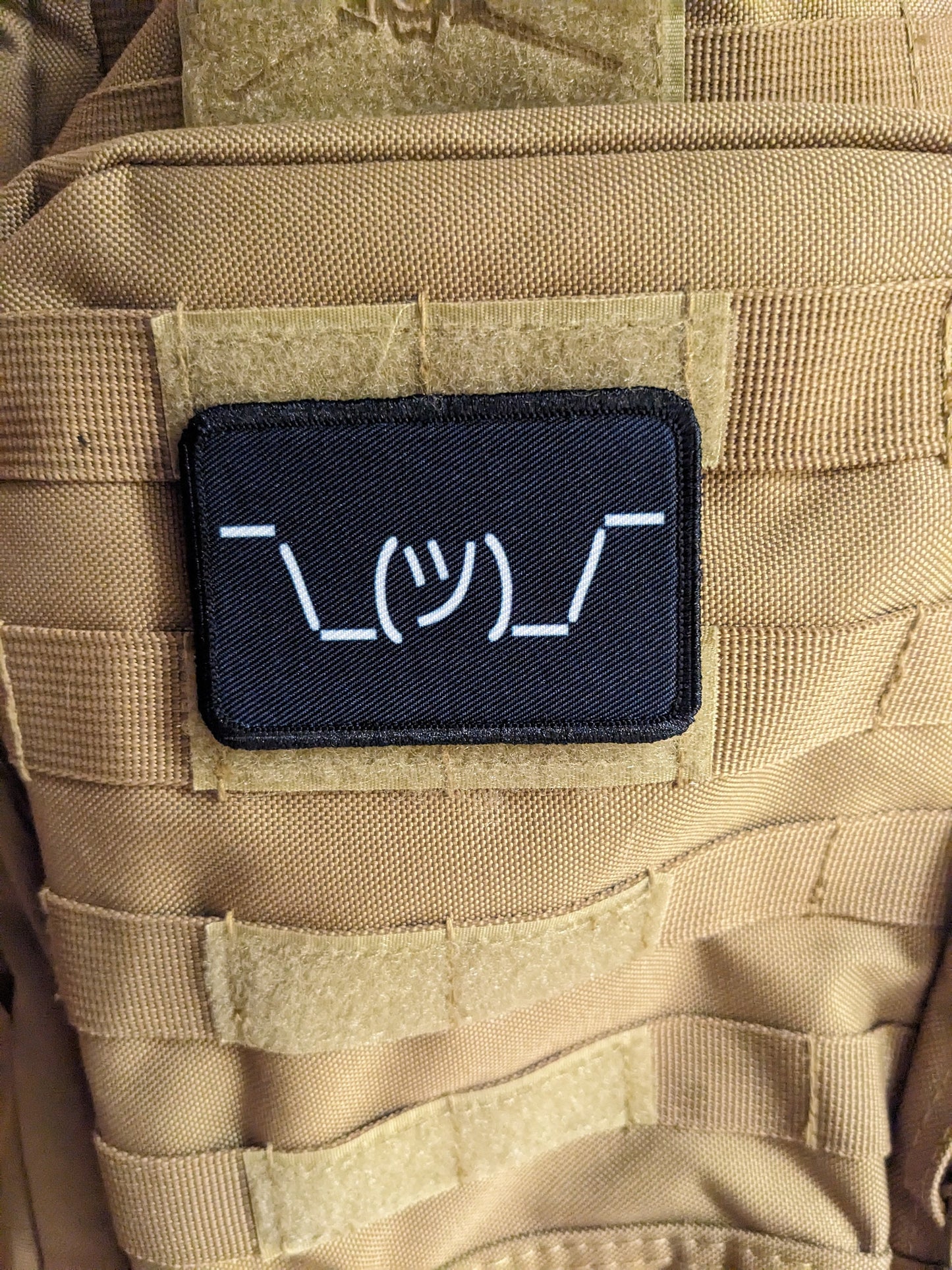 Text idk guy shrugging shoulders black background meme 2"x3" morale patch with hook and loop backing