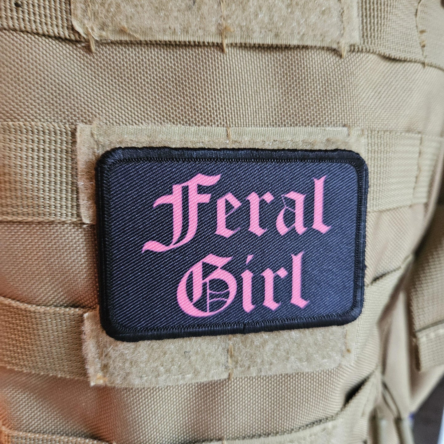 Pink on black "feral girl" girls and boys meme 2"x3" morale patch with hook and loop backing