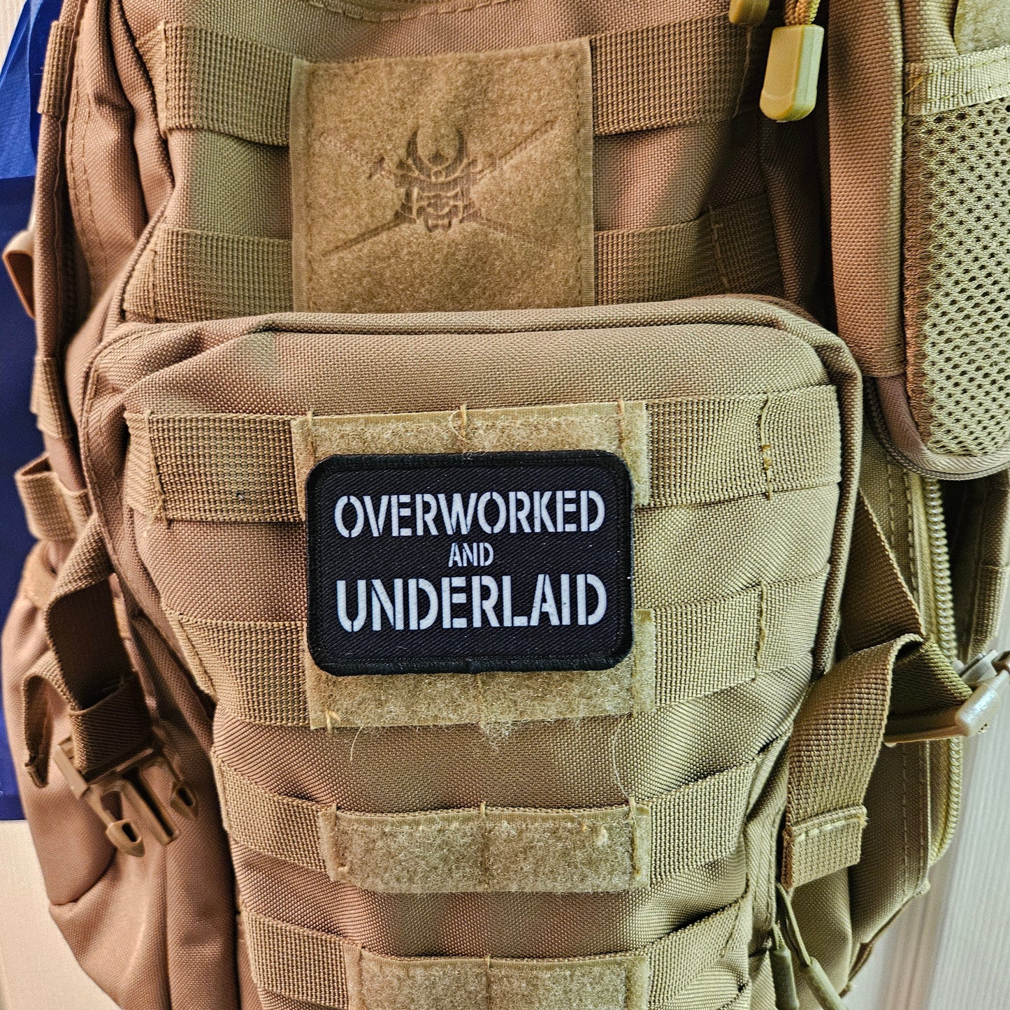 Overworked and underlaid 2"x3" removable morale patch with hook and loop backing black and white