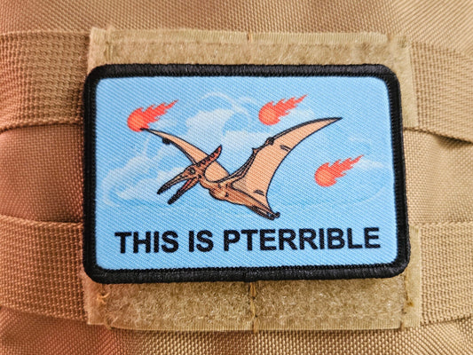 This is pterrible pterodactyl meme 2"x3" morale patch with hook and loop backing