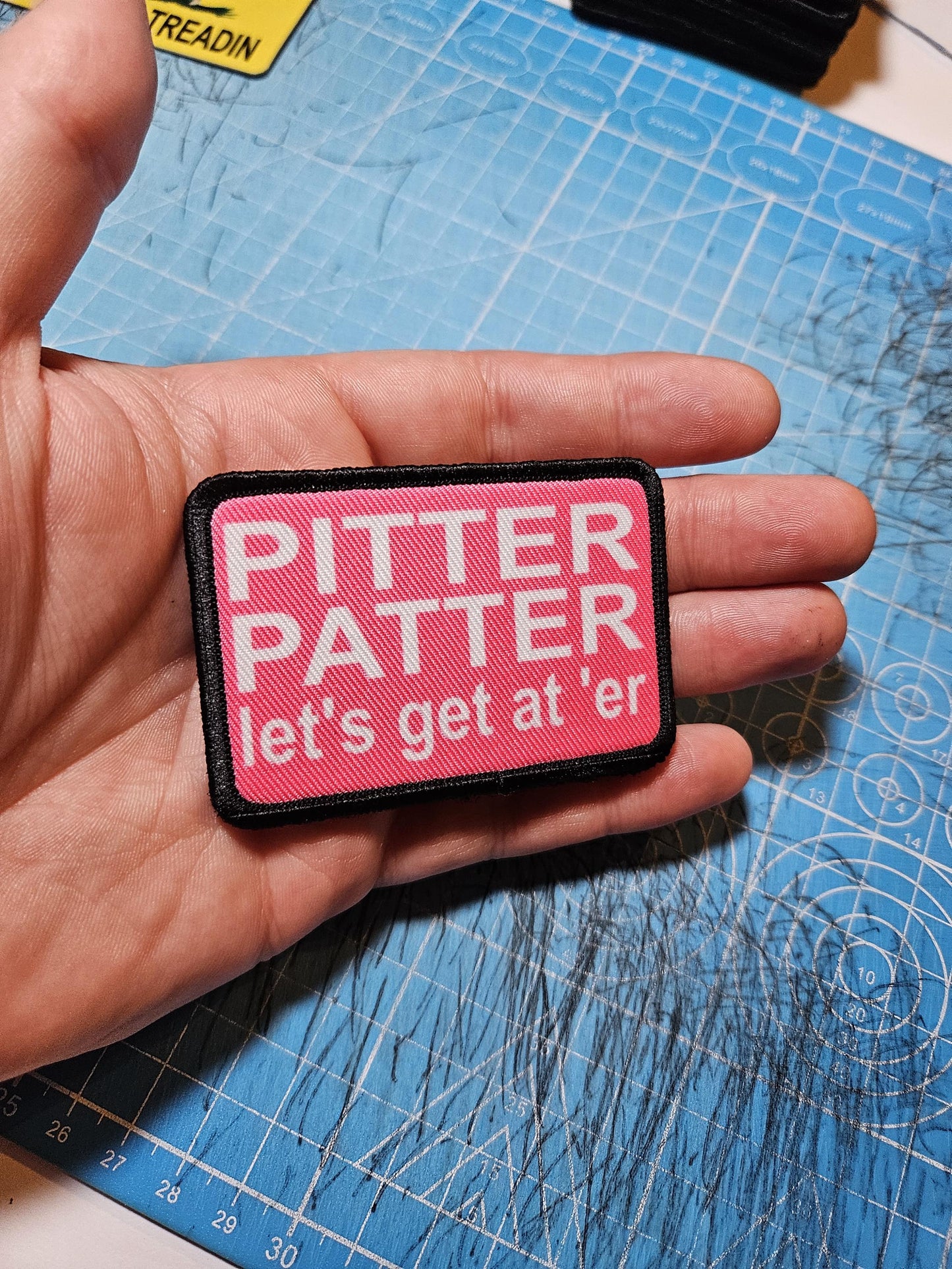 pink and white Pitter patter let's get at 'er meme 2"x3" removable morale patch with hook and loop backing