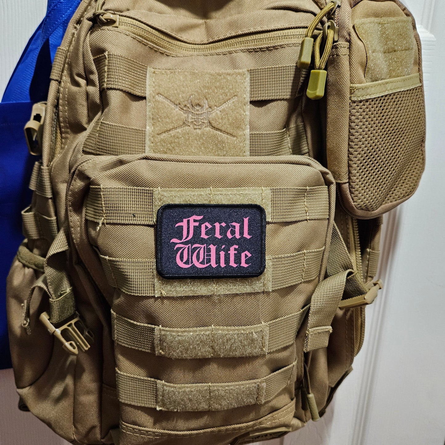 Feral wife meme 2"x3" morale patch with hook and loop backing pink on black