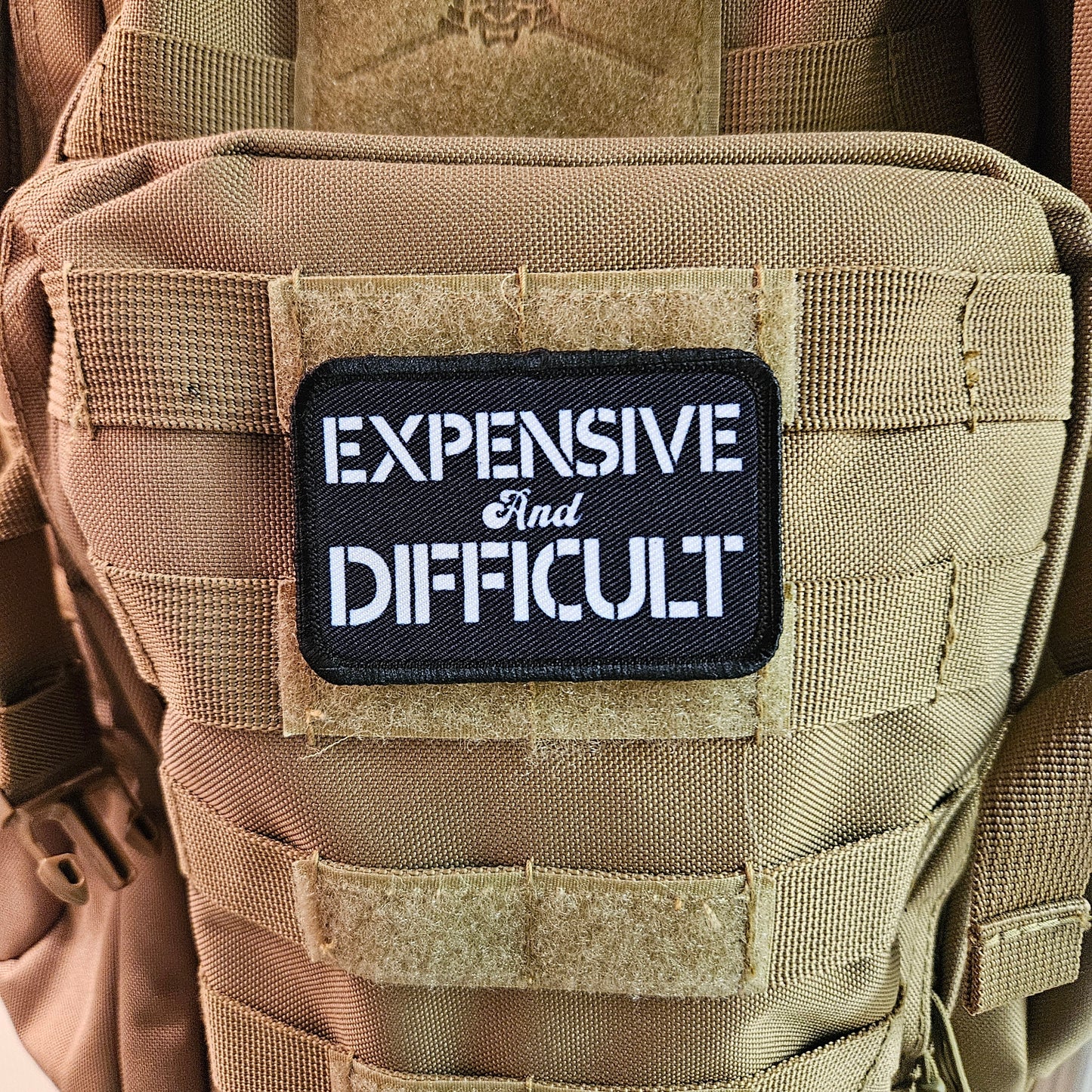 Expensive  and difficult meme black 2"x3" removable morale patch with hook and loop backing