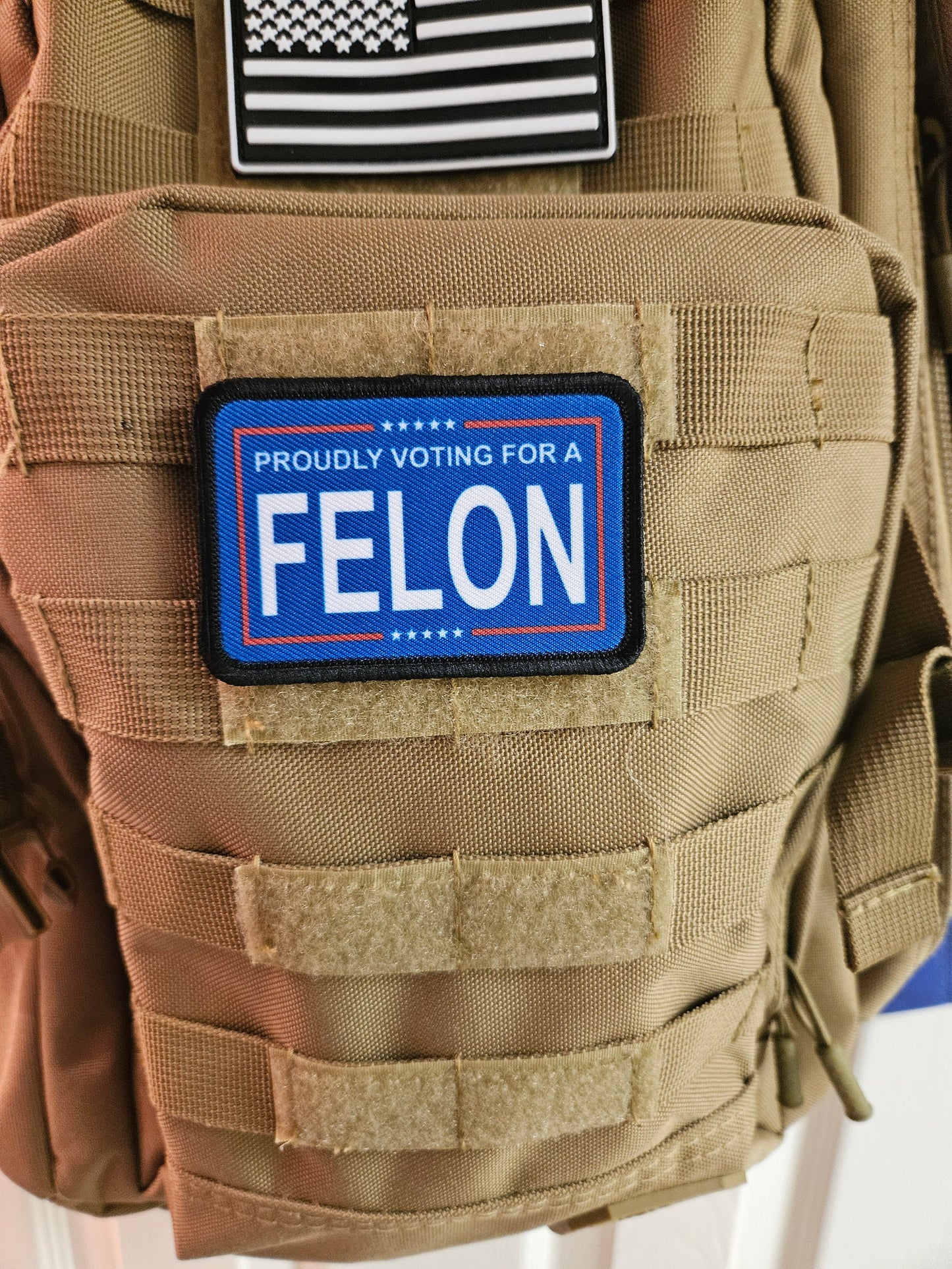 Proudly voting for a felon blue 2"x3" removable morale patch with hook and loop backing meme
