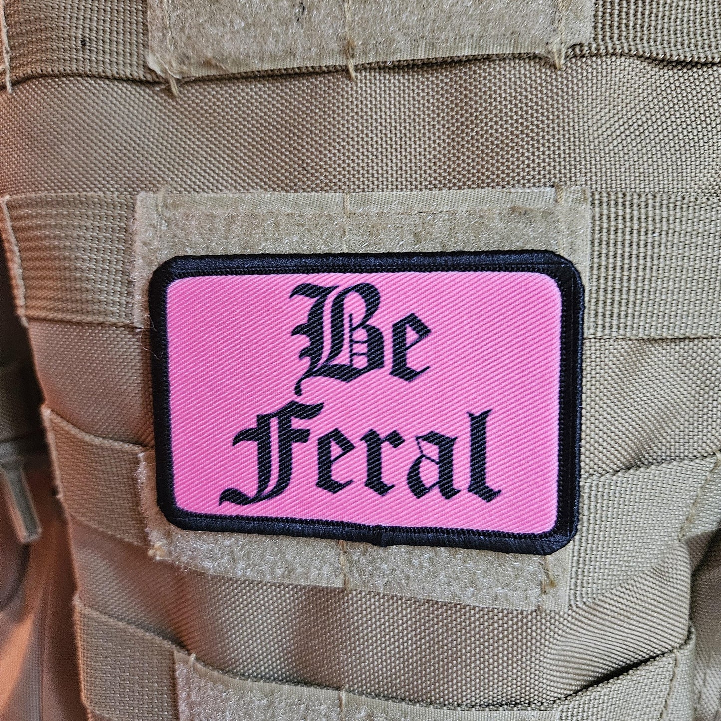 Pink "be feral" girls and boys meme 2"x3" morale patch with hook and loop backing