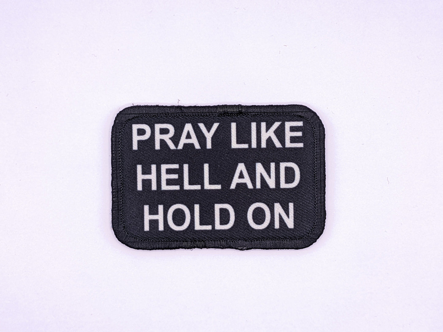 Pray Like HELL and HOLD on Yellowstone quote 2"x3" morale patch with hook and loop backing green background