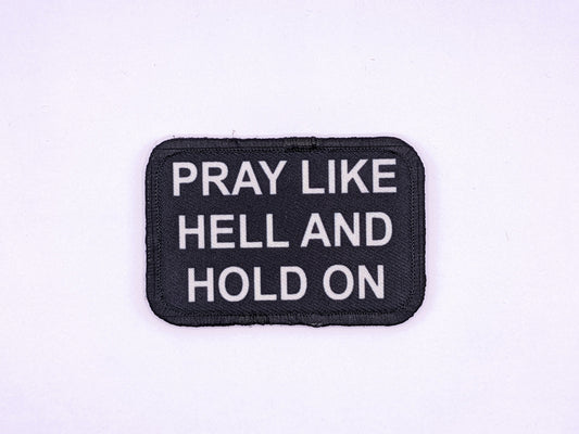 Pray Like HELL and HOLD on Yellowstone quote 2"x3" morale patch with hook and loop backing green background