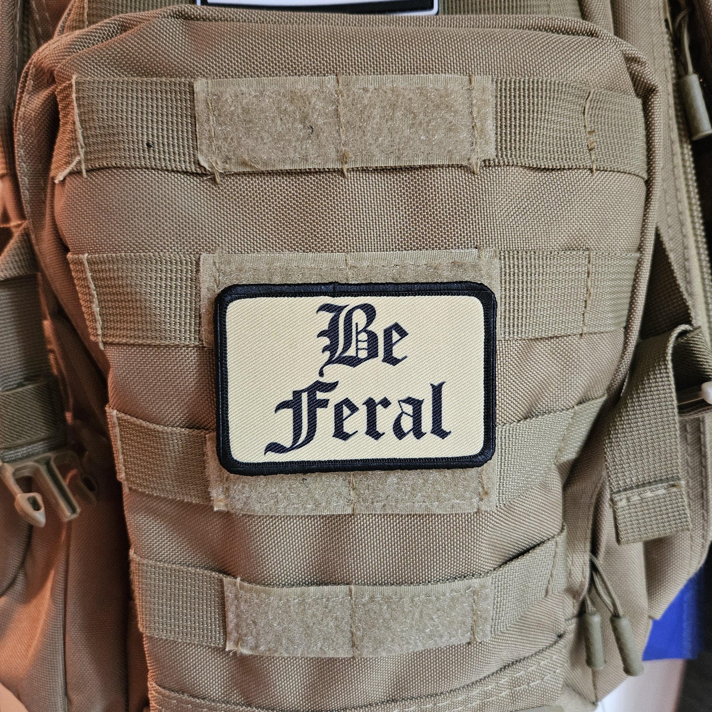 Tan "be feral" girls and boys meme 2"x3" morale patch with hook and loop backing