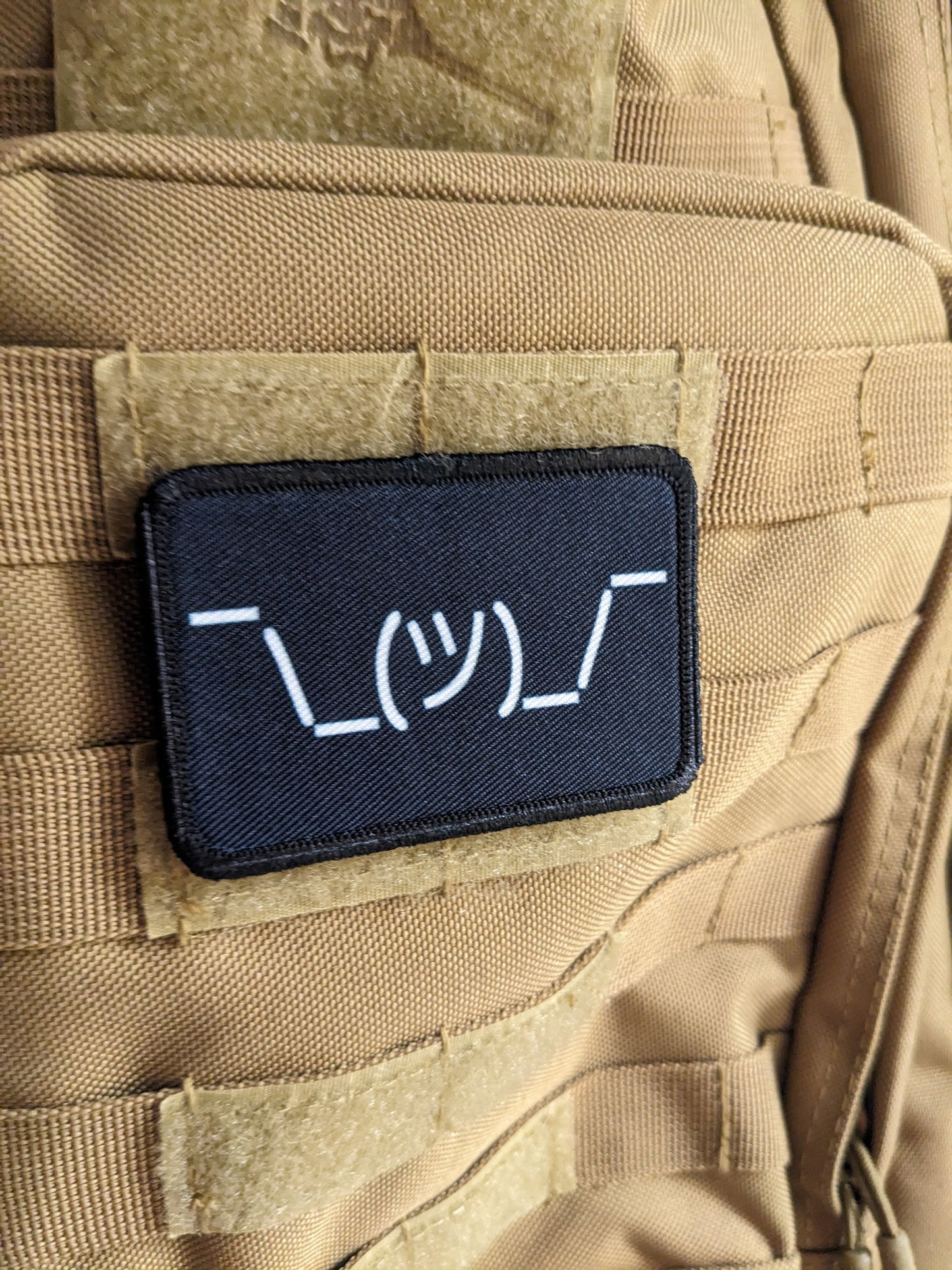Text idk guy shrugging shoulders black background meme 2"x3" morale patch with hook and loop backing