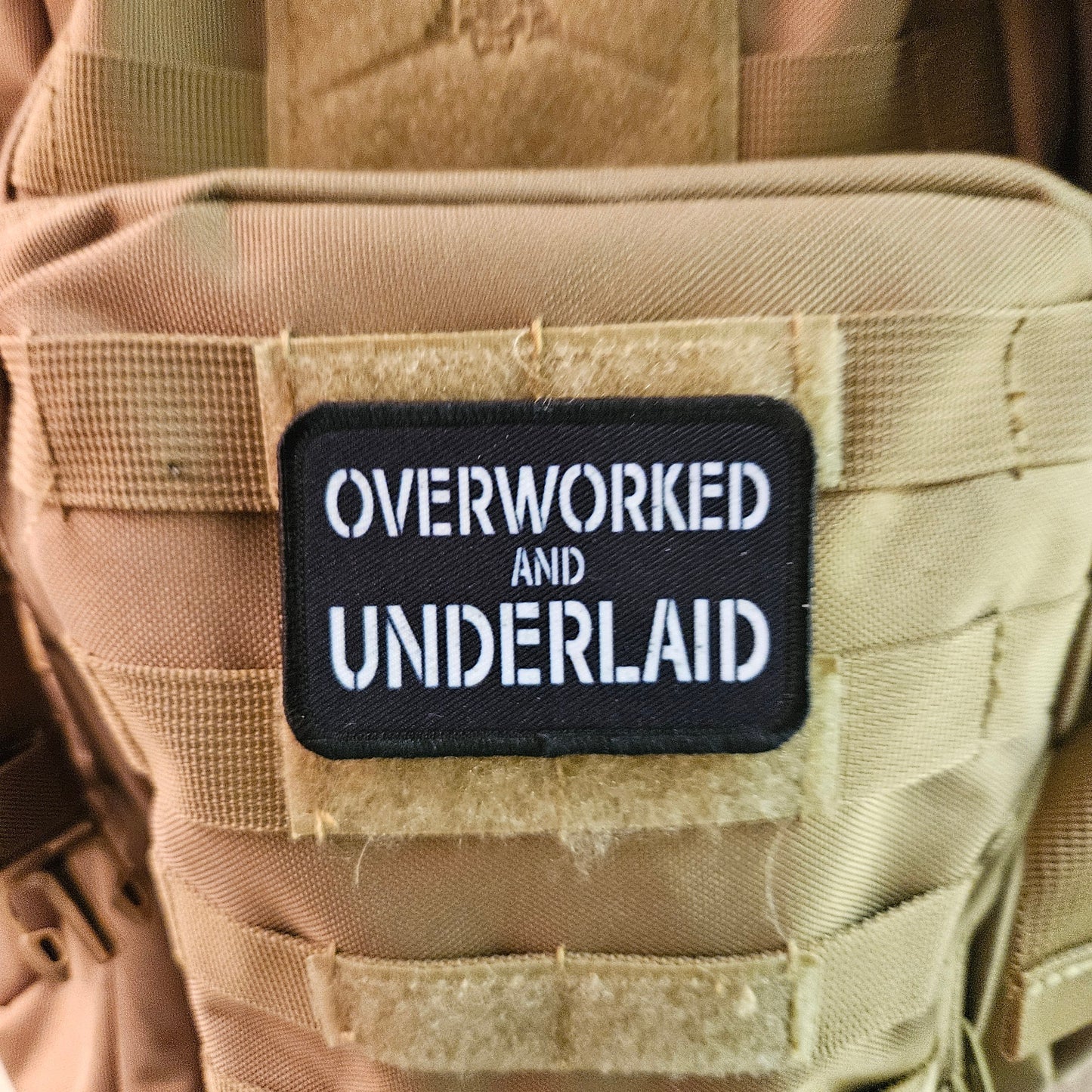 Overworked and underlaid 2"x3" removable morale patch with hook and loop backing black and white