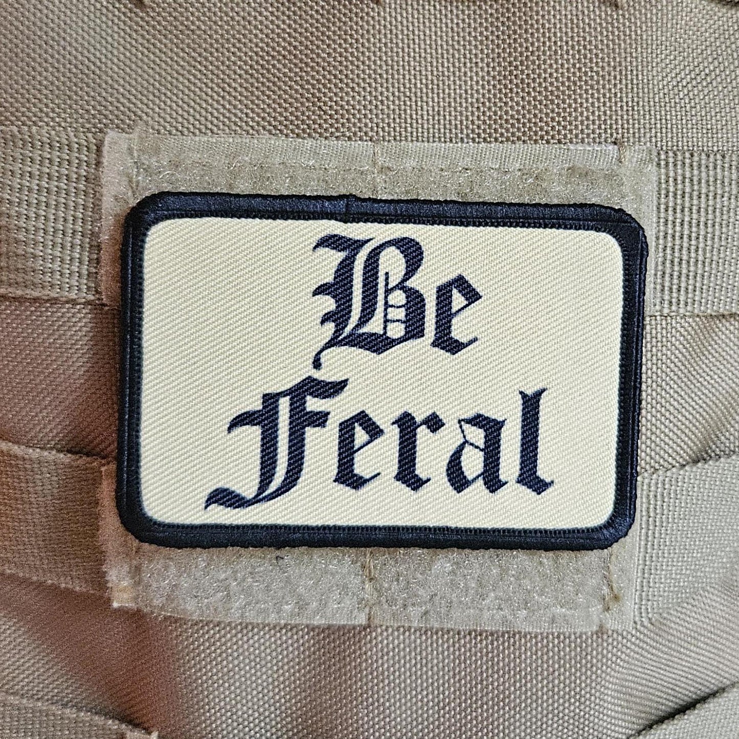 Tan "be feral" girls and boys meme 2"x3" morale patch with hook and loop backing