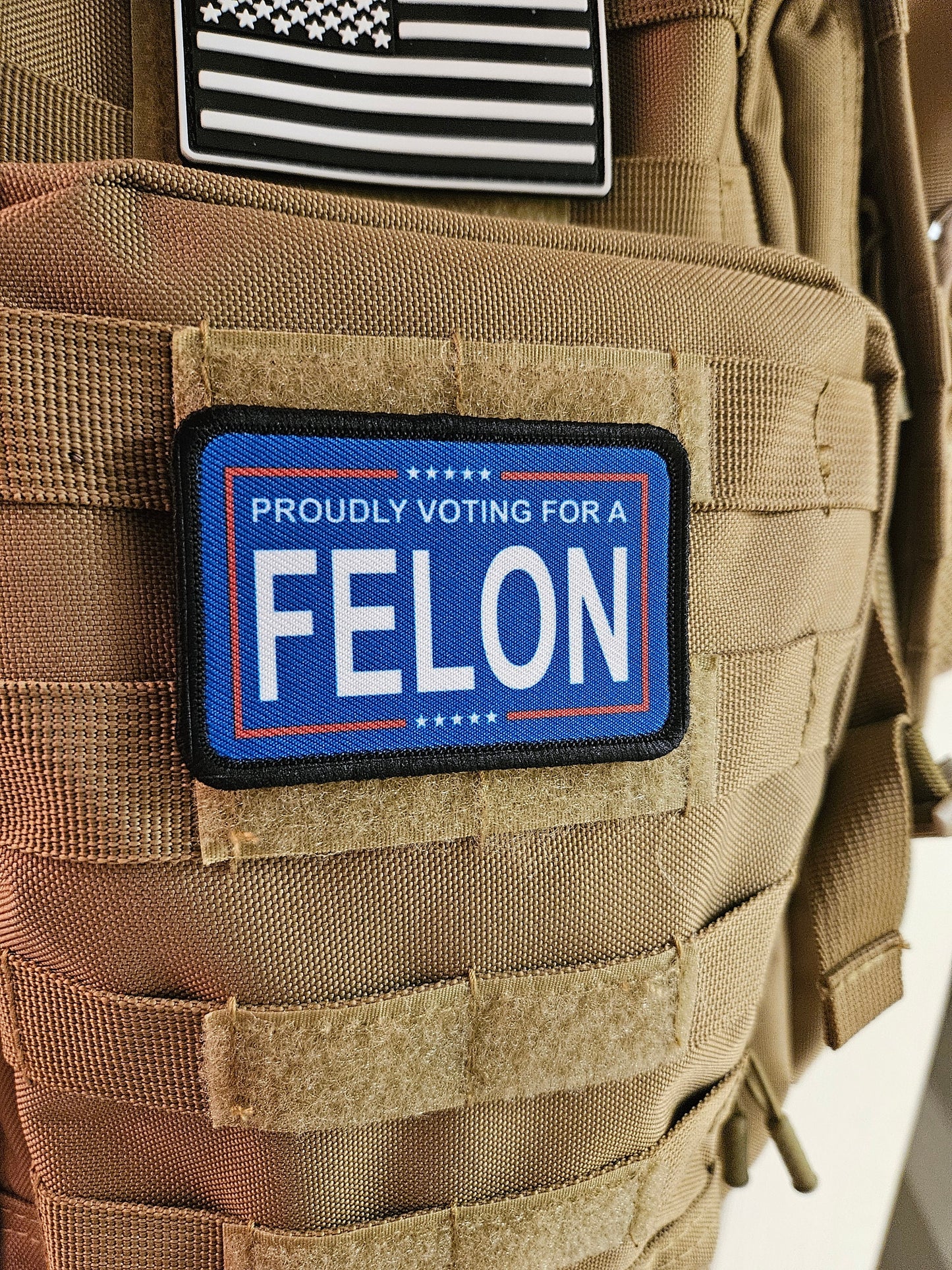 Proudly voting for a felon blue 2"x3" removable morale patch with hook and loop backing meme