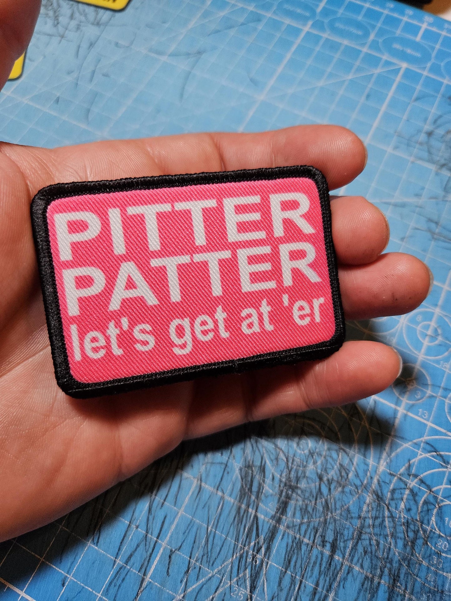 pink and white Pitter patter let's get at 'er meme 2"x3" removable morale patch with hook and loop backing