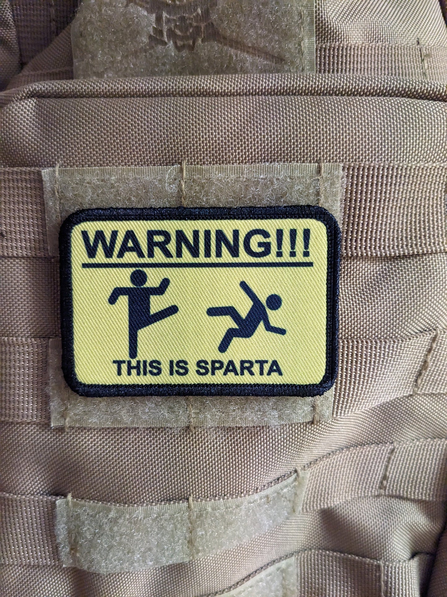 This is Sparta warning sign meme 2"x3" morale patch with hook and loop backing