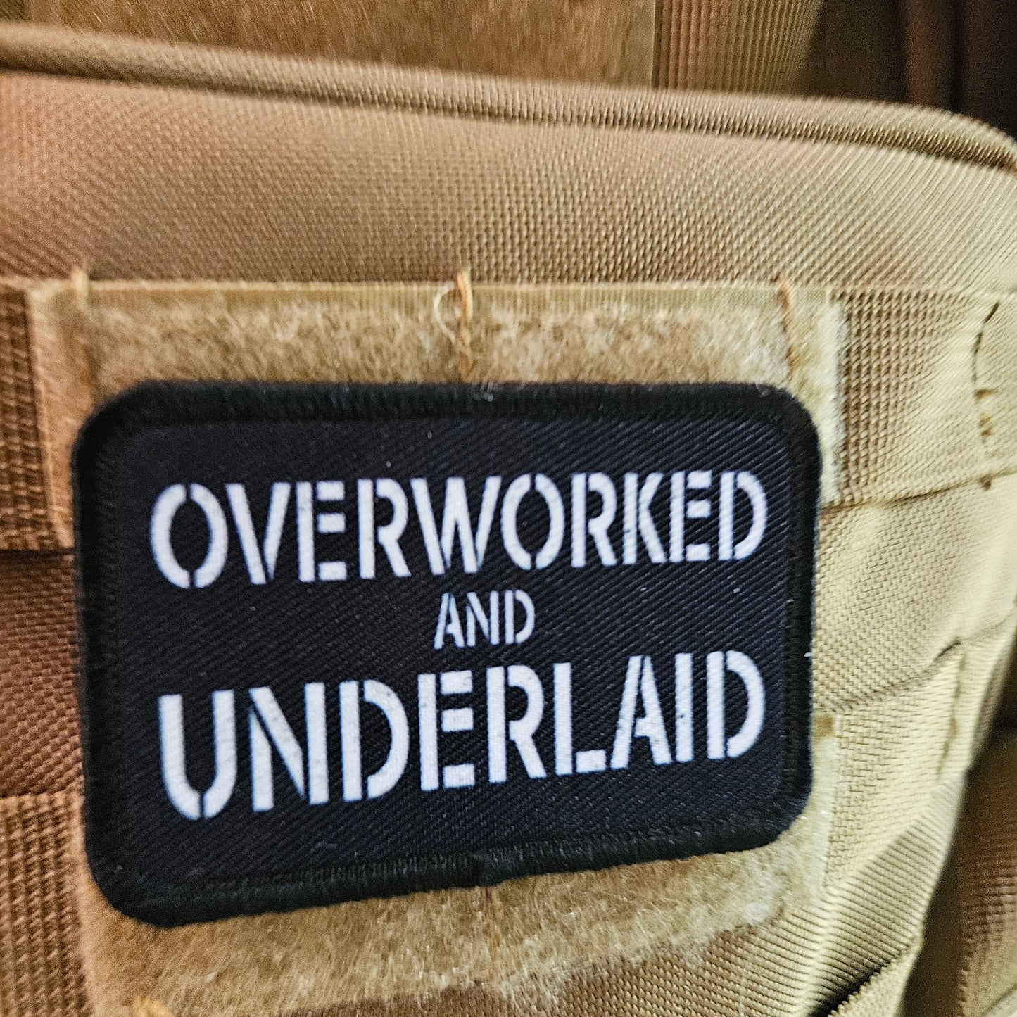 Overworked and underlaid 2"x3" removable morale patch with hook and loop backing black and white