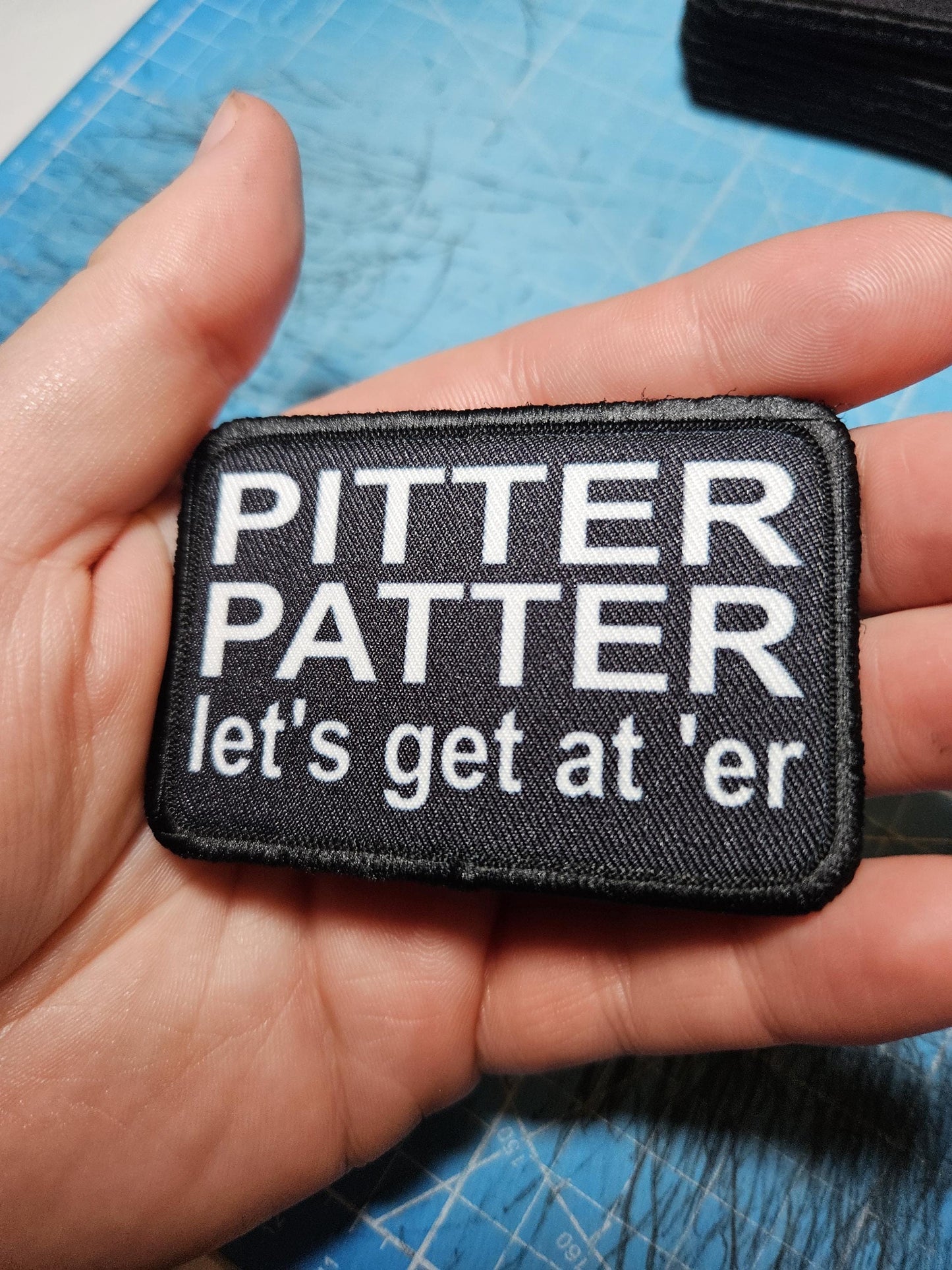 Pitter patter let's get at 'er meme 2"x3" removable morale patch with hook and loop backing black and white