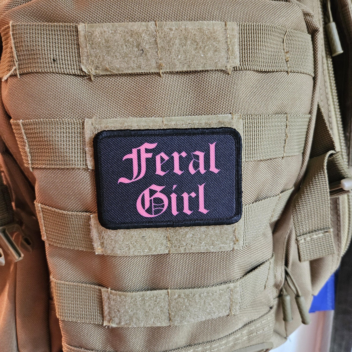 Pink on black "feral girl" girls and boys meme 2"x3" morale patch with hook and loop backing