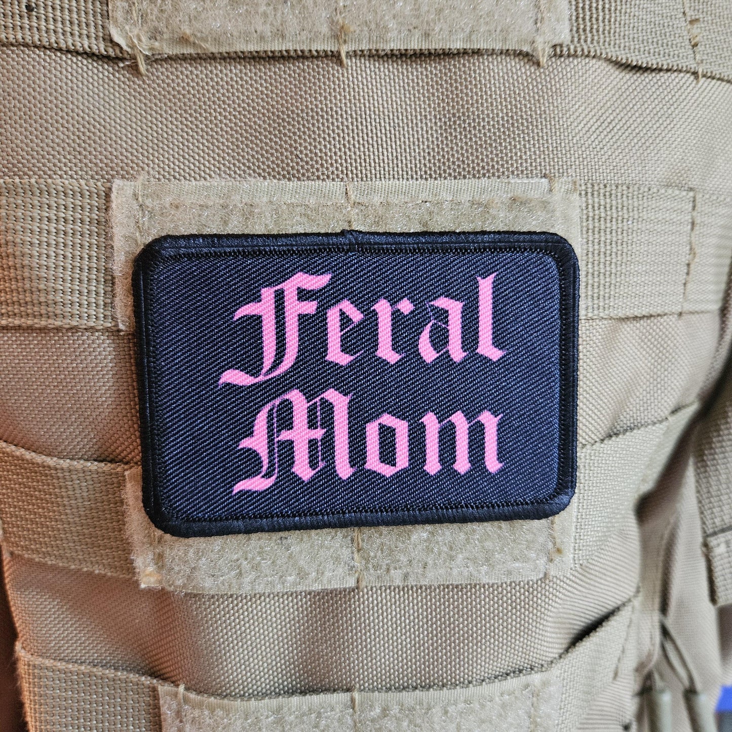 Pink on black "feral mom" girls and boys meme 2"x3" morale patch with hook and loop backing