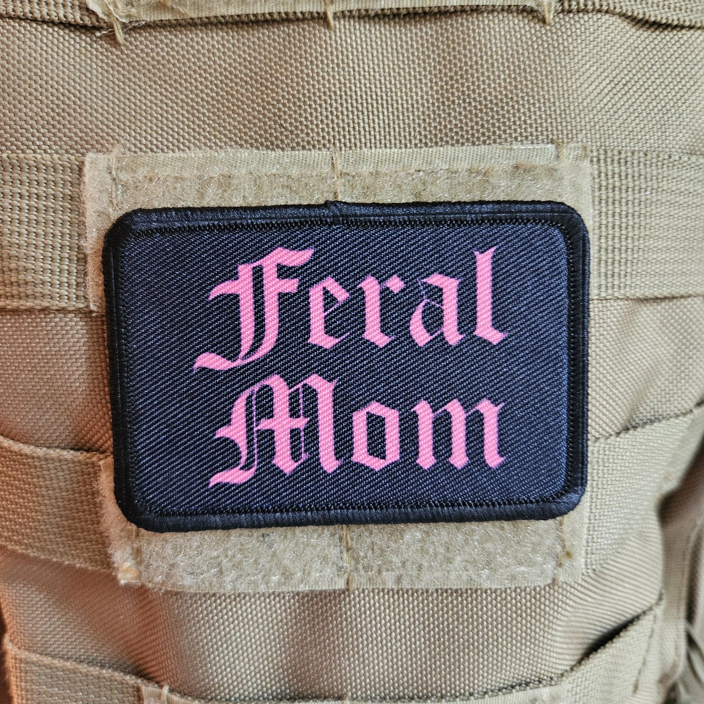 Pink on black "feral mom" girls and boys meme 2"x3" morale patch with hook and loop backing