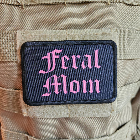Pink on black "feral mom" girls and boys meme 2"x3" morale patch with hook and loop backing