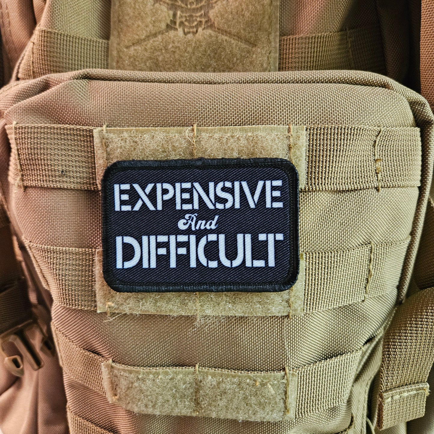 Expensive  and difficult meme black 2"x3" removable morale patch with hook and loop backing
