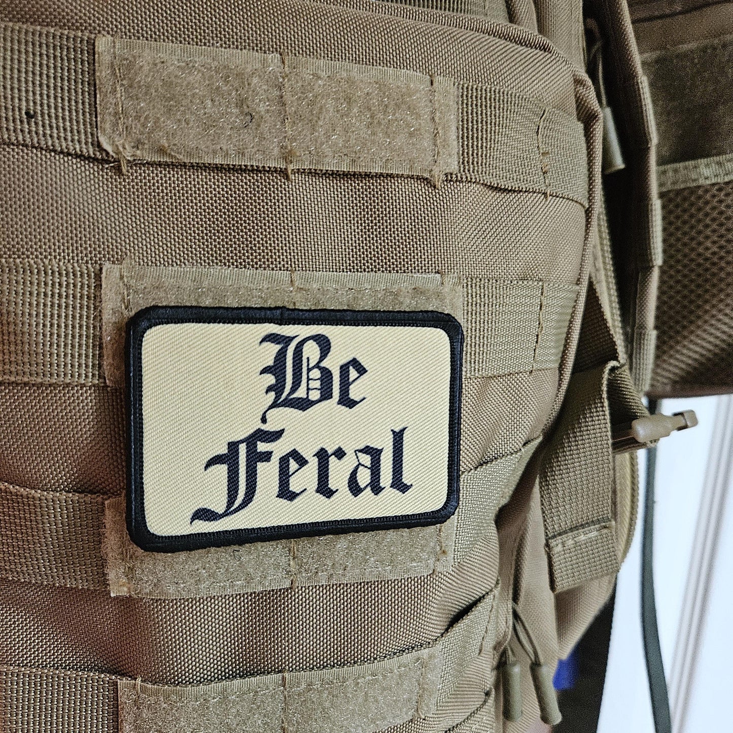Tan "be feral" girls and boys meme 2"x3" morale patch with hook and loop backing