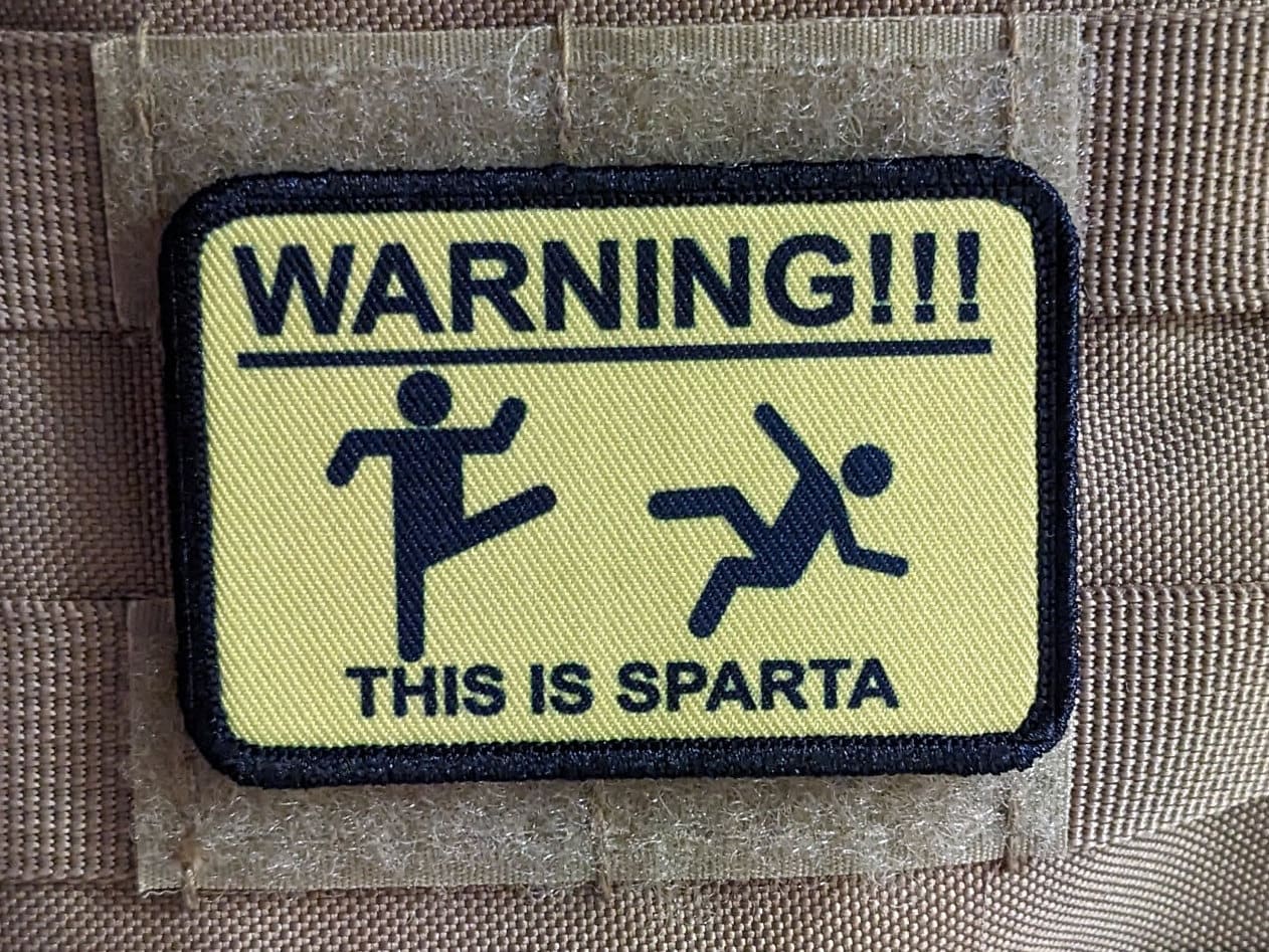 This is Sparta warning sign meme 2"x3" morale patch with hook and loop backing